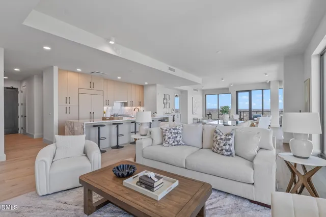 a living room with patio furniture and a potted plant