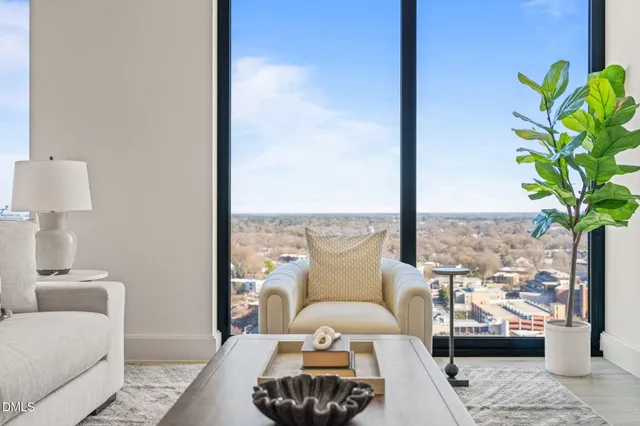a living room with furniture and large windows