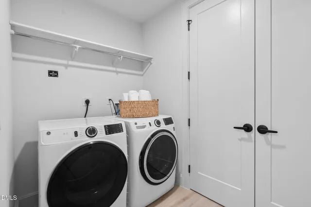a white bath tub sitting next to a white sink and vanity