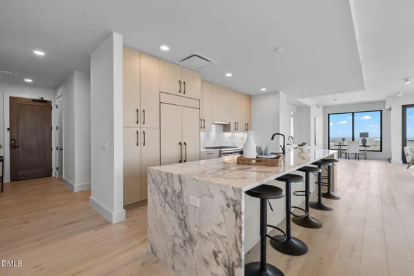 a kitchen with stainless steel appliances granite countertop a stove and a refrigerator