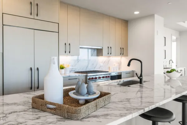 a living room with furniture a dining table and a potted plant