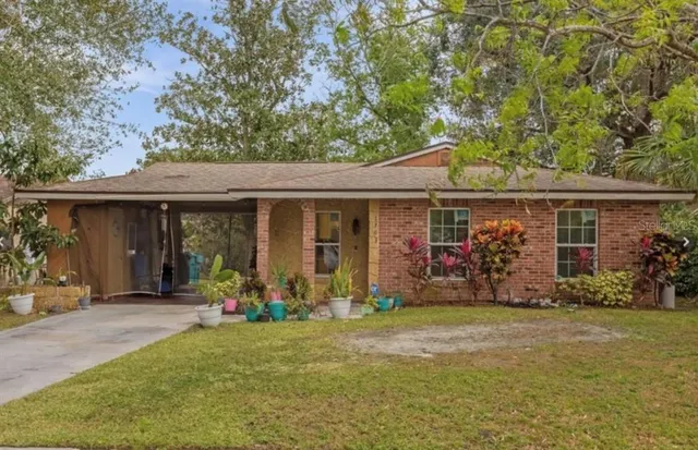 a front view of a house with lots of windows and plants