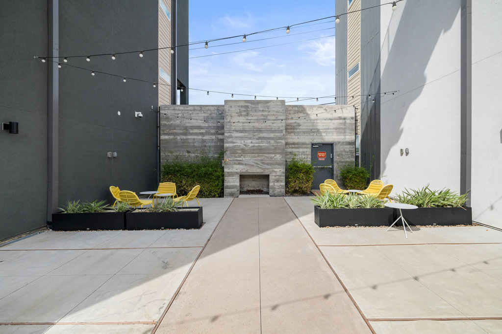 4801 Springdale Road, Unit 1106 Austin, TX 78723 - Photo 15 of 40 a building outdoor space with patio furniture and a fireplace