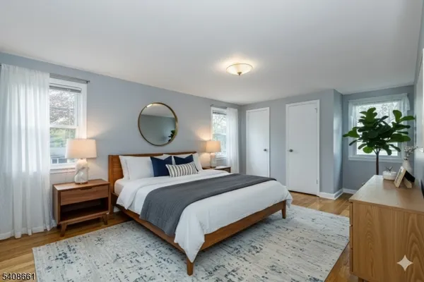 a bedroom with a bed lamp and a potted plant