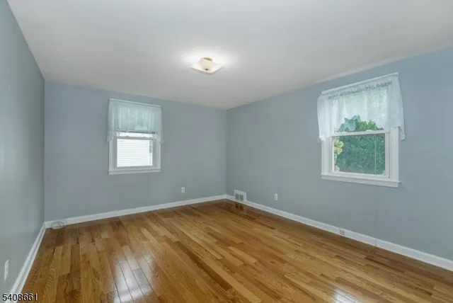 a view of room with window and hardwood floor