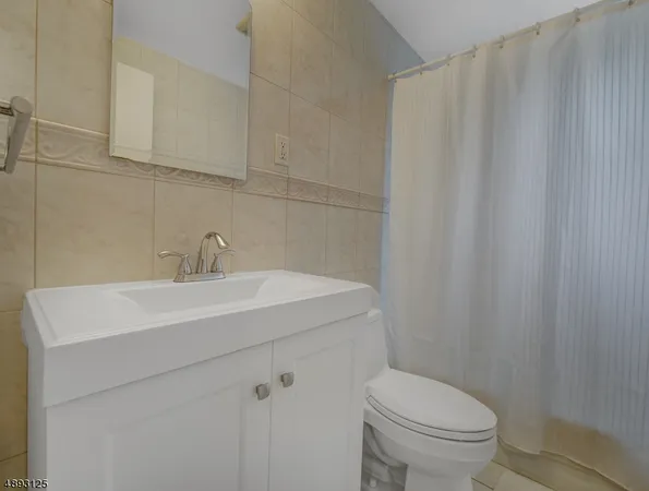 a bathroom with a sink a toilet and vanity