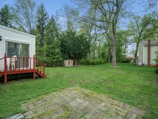 a view of a house with a yard and a tree
