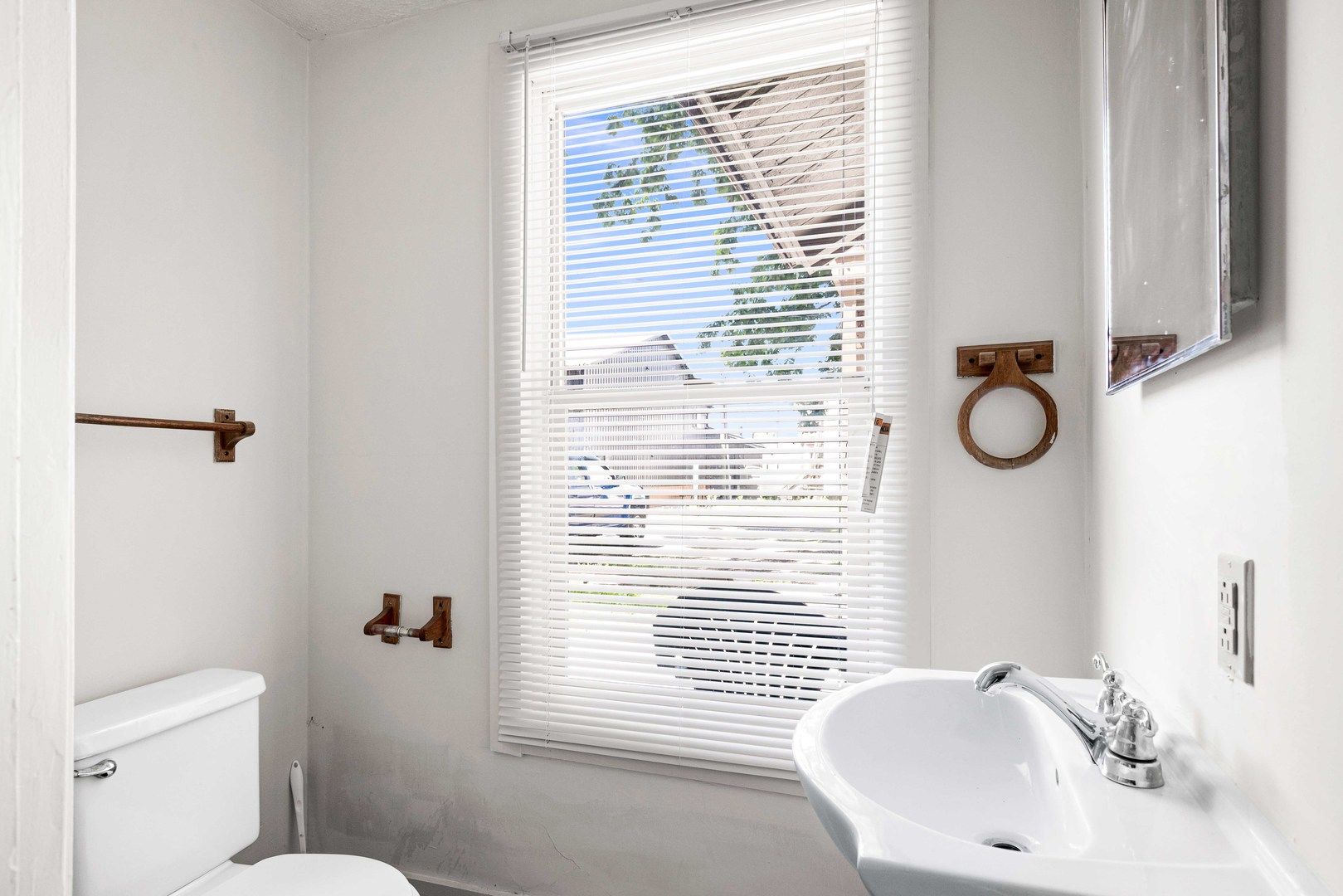 410 East Grove Street Bloomington, IL 61701 - Photo 14 of 25 a bathroom with a sink a toilet and a mirror