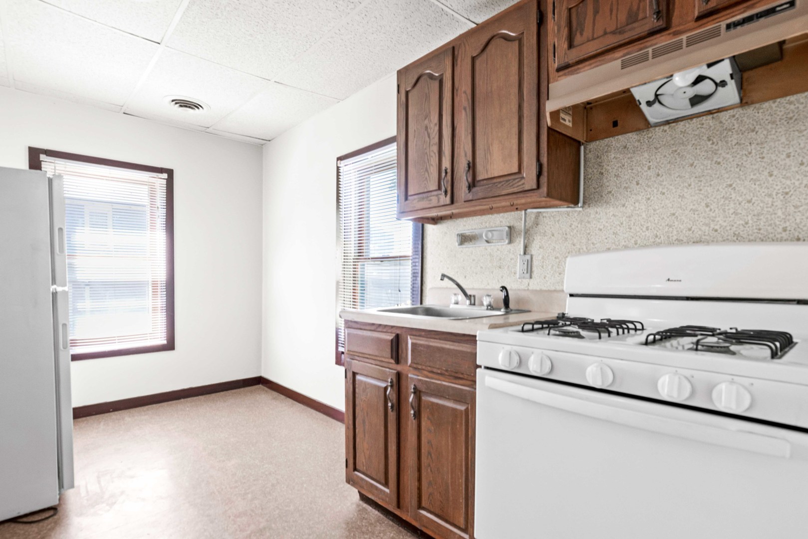 410 East Grove Street Bloomington, IL 61701 - Photo 21 of 25 a kitchen with stainless steel appliances granite countertop a stove a sink and a microwave