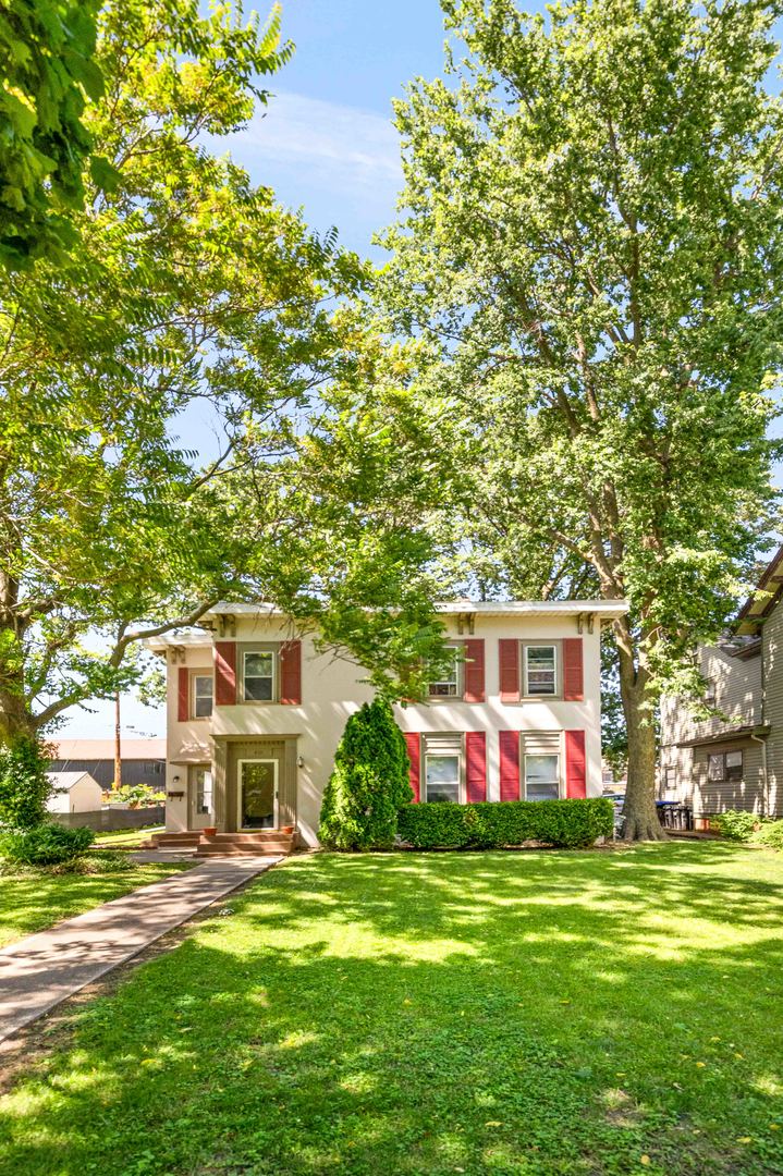410 East Grove Street Bloomington, IL 61701 - Photo 25 of 25 a front view of house with yard and trees in the background