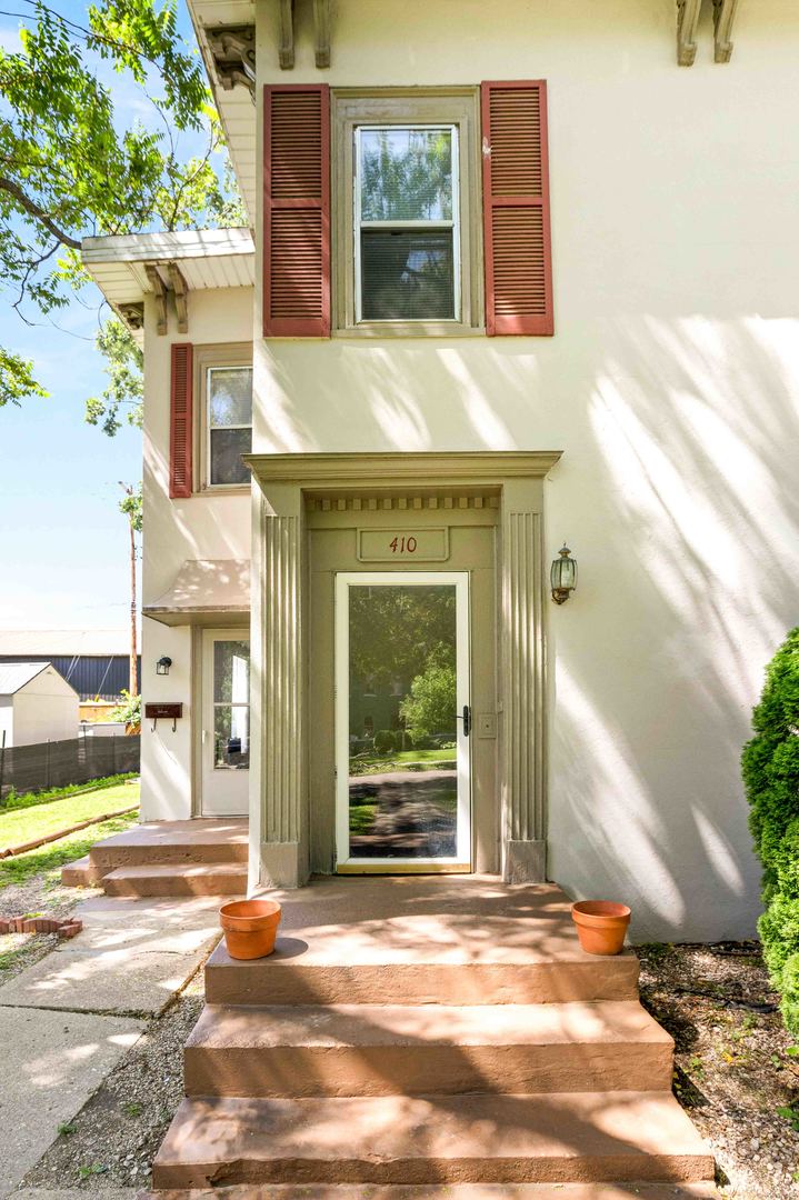 410 East Grove Street Bloomington, IL 61701 - Photo 3 of 25 a view of a brick house with many windows