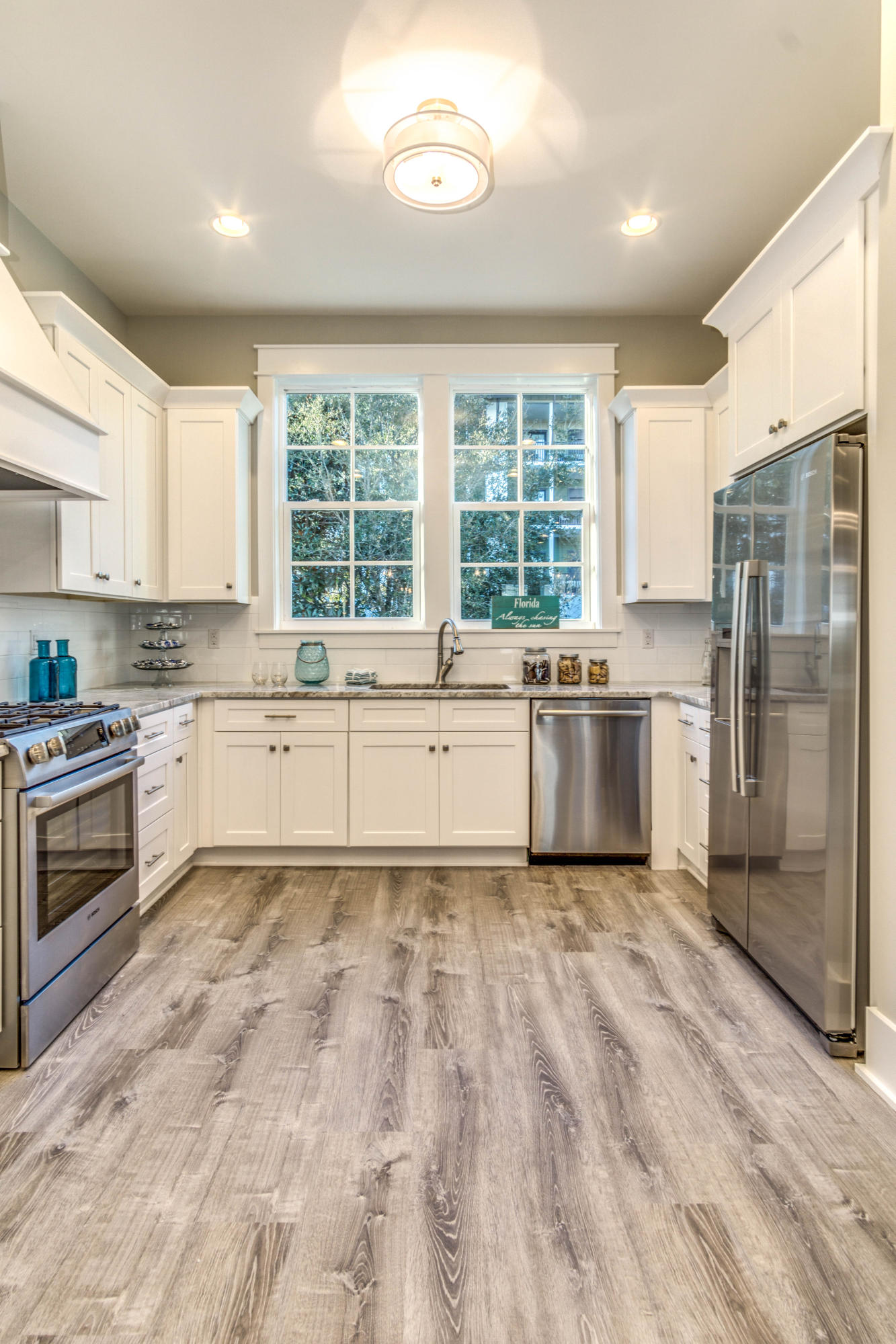 166 Cabana Trail Santa Rosa Beach, FL 32459 - Photo 19 of 62 a large white kitchen with granite countertop a stove top oven sink and cabinets