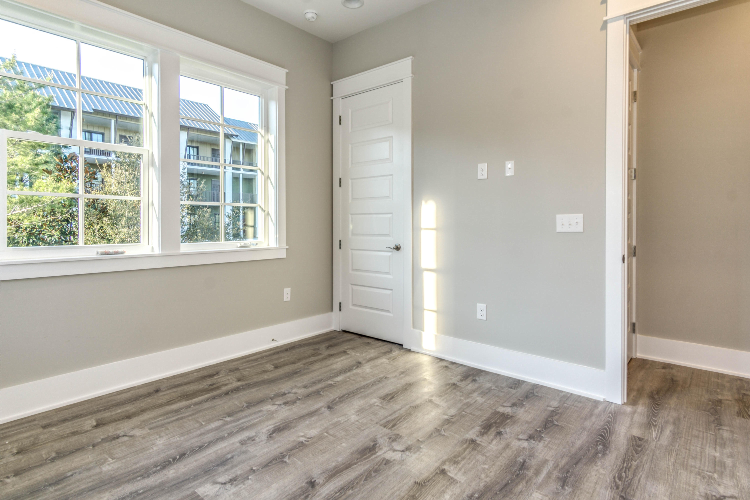 166 Cabana Trail Santa Rosa Beach, FL 32459 - Photo 39 of 62 an empty room with wooden floor and windows