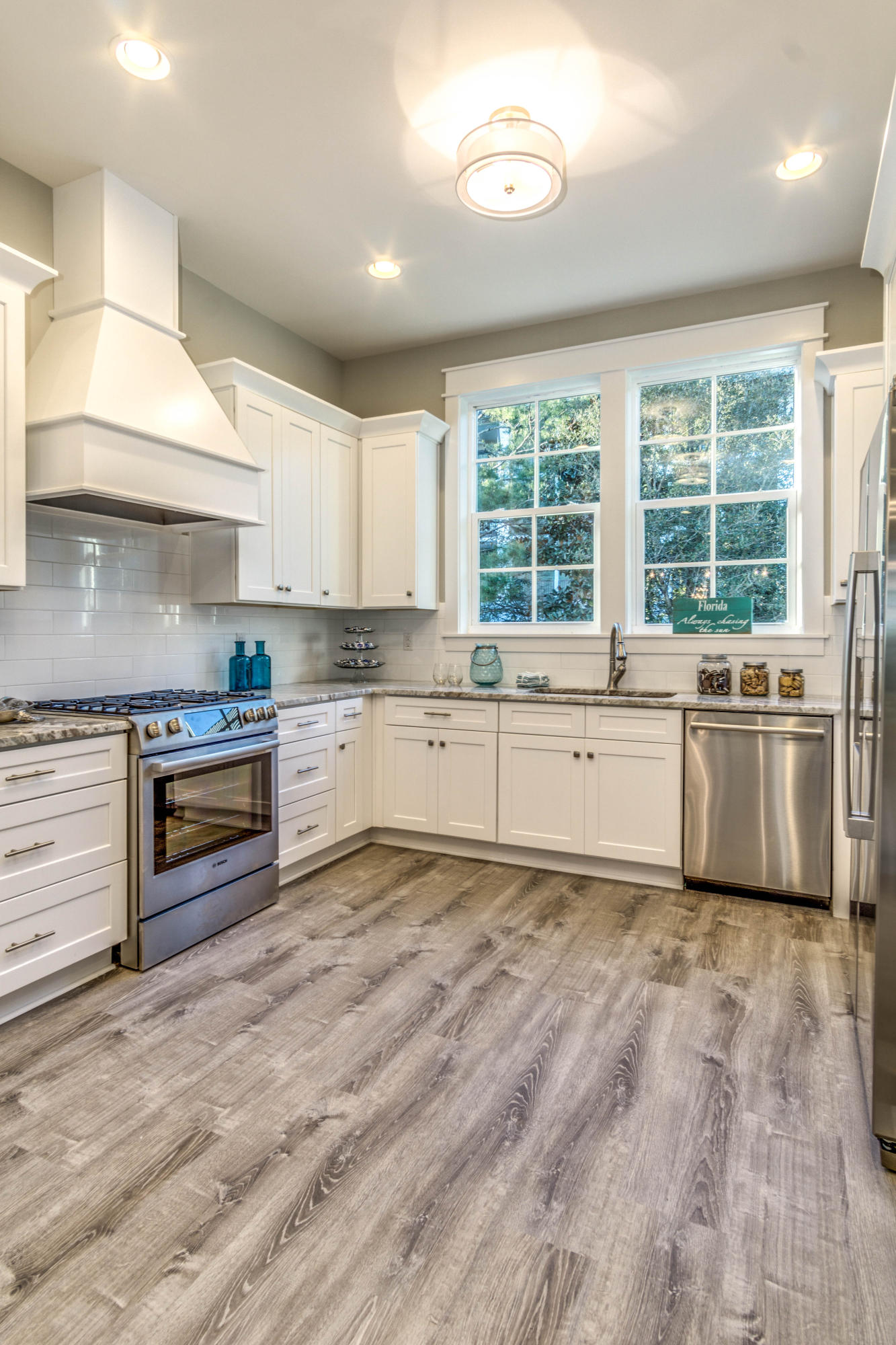 166 Cabana Trail Santa Rosa Beach, FL 32459 - Photo 6 of 62 a kitchen with granite countertop a stove top oven sink and cabinets
