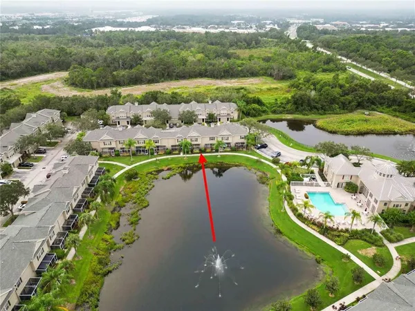 an aerial view of a house with a lake view