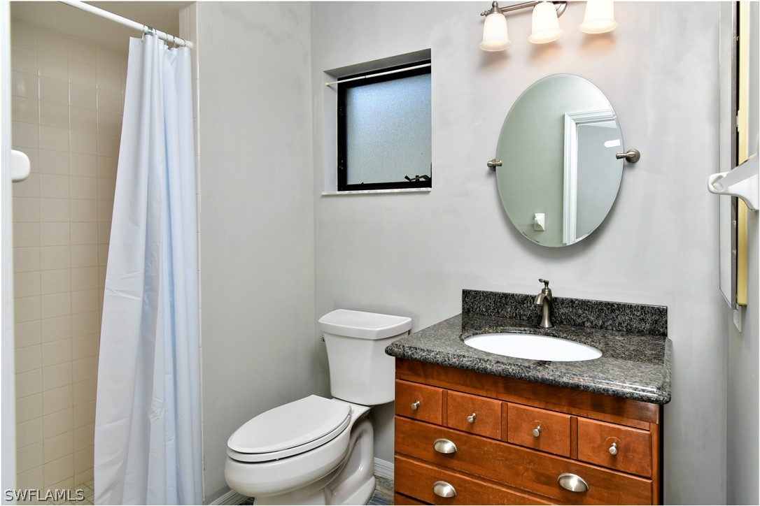13273 Heather Ridge Loop Fort Myers, FL 33966 - Photo 14 of 21 a bathroom with a toilet a sink and mirror