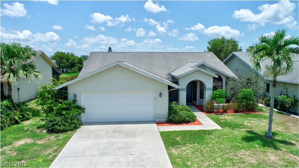 13273 Heather Ridge Loop Fort Myers, FL 33966 - Photo 2 of 21 a front view of a house with garden