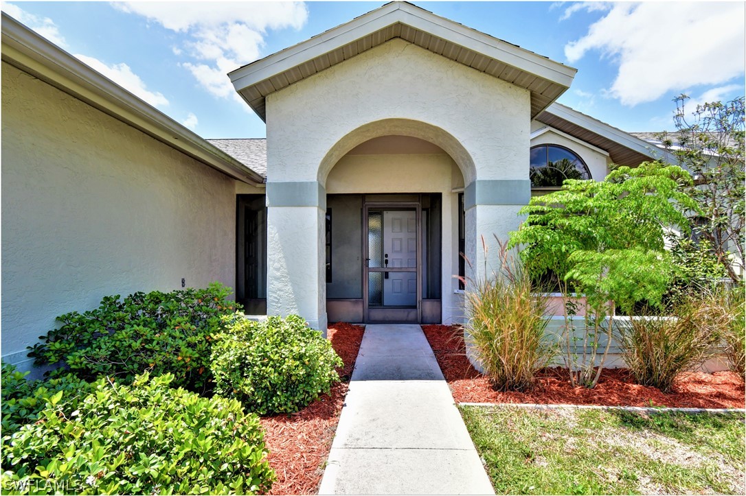 13273 Heather Ridge Loop Fort Myers, FL 33966 - Photo 5 of 21 a front view of a house with a yard