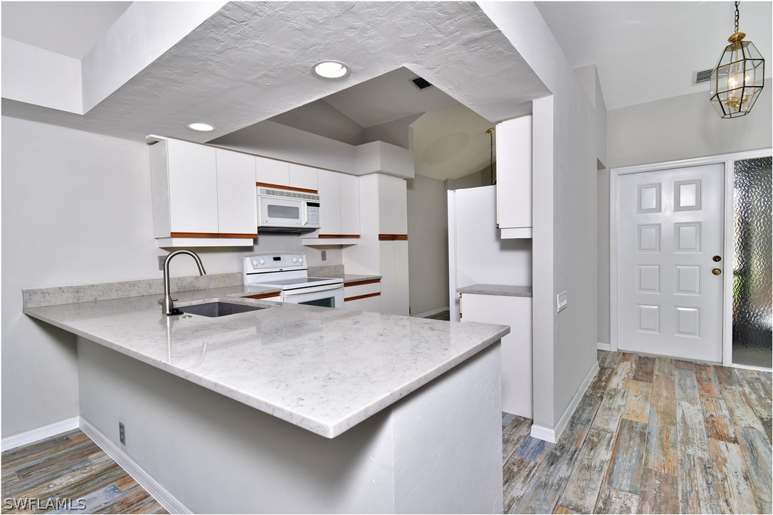 13273 Heather Ridge Loop Fort Myers, FL 33966 - Photo 6 of 21 a kitchen with stainless steel appliances a sink stove and refrigerator