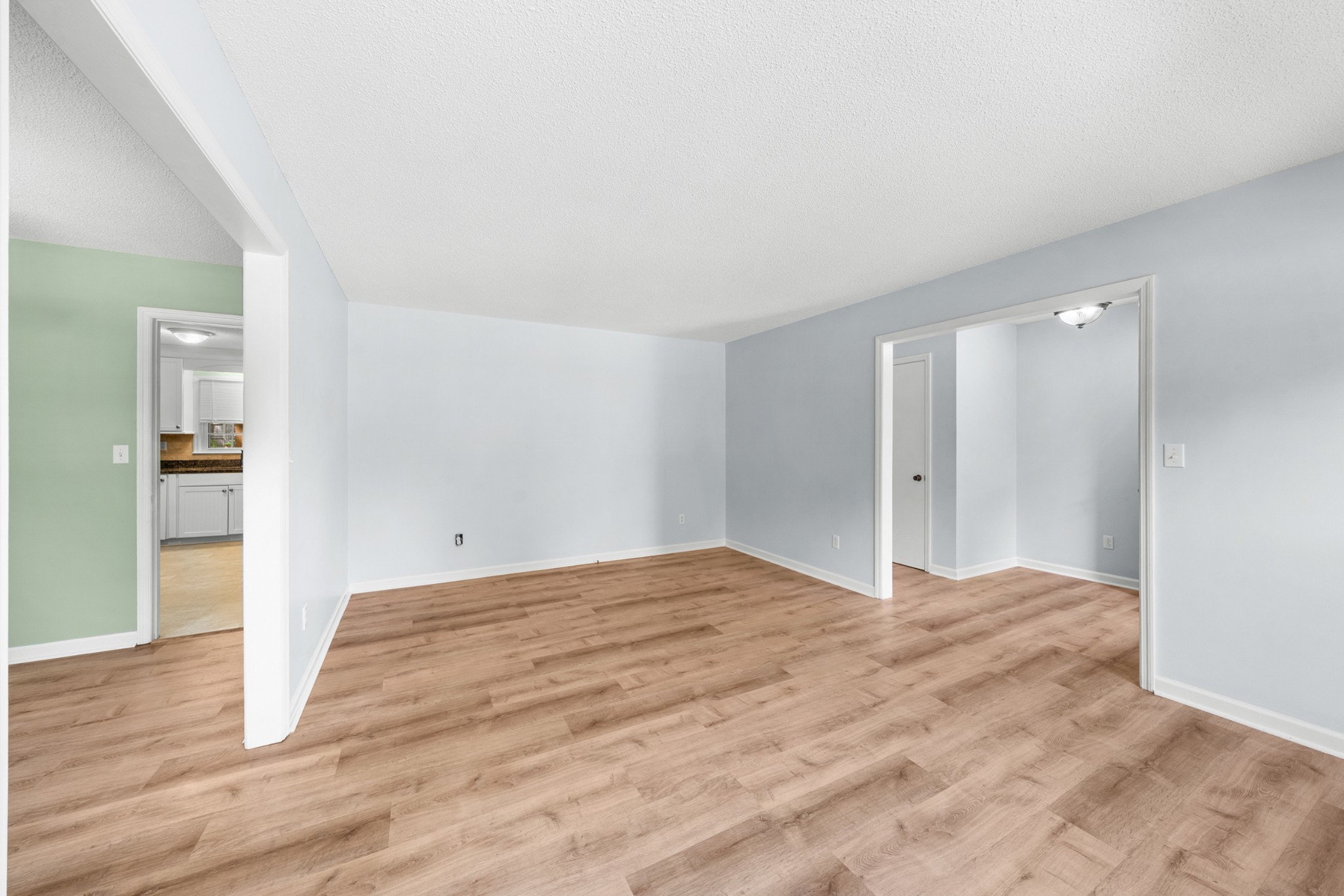50 Maple Drive Winchester, TN 37398 - Photo 20 of 47 a view of an empty room with wooden floor and a kitchen
