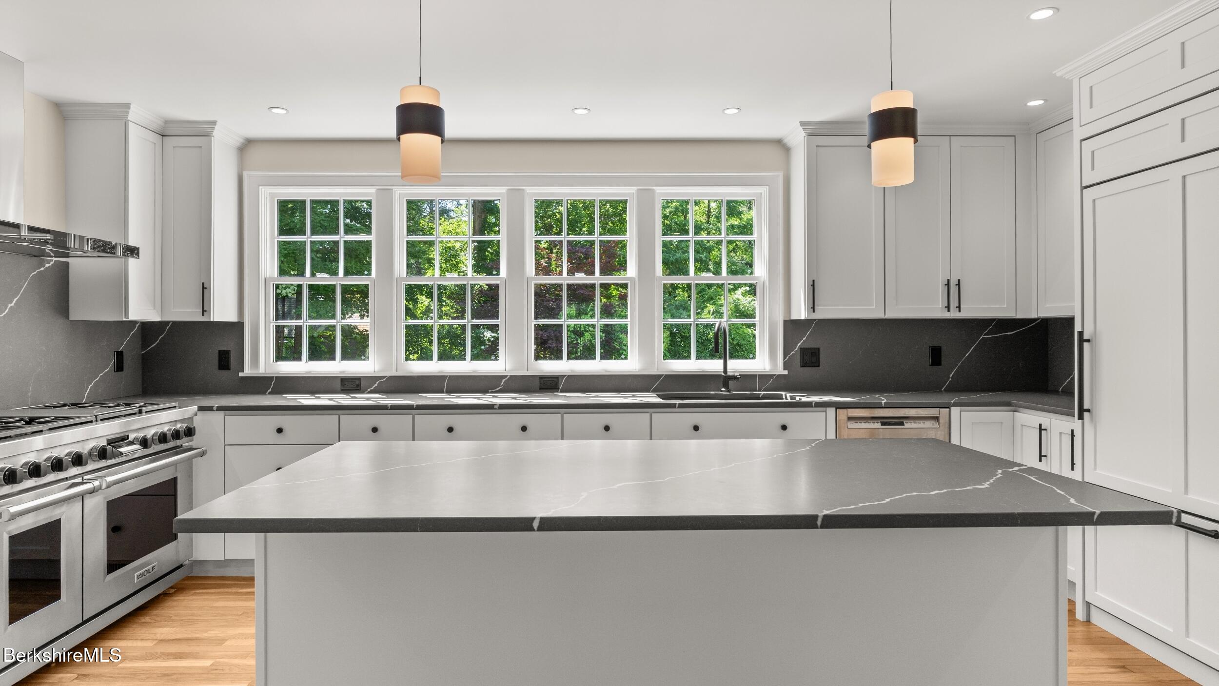 55 Main Street Stockbridge, MA 01262 - Photo 11 of 54 a kitchen with stainless steel appliances granite countertop a stove a sink and a microwave