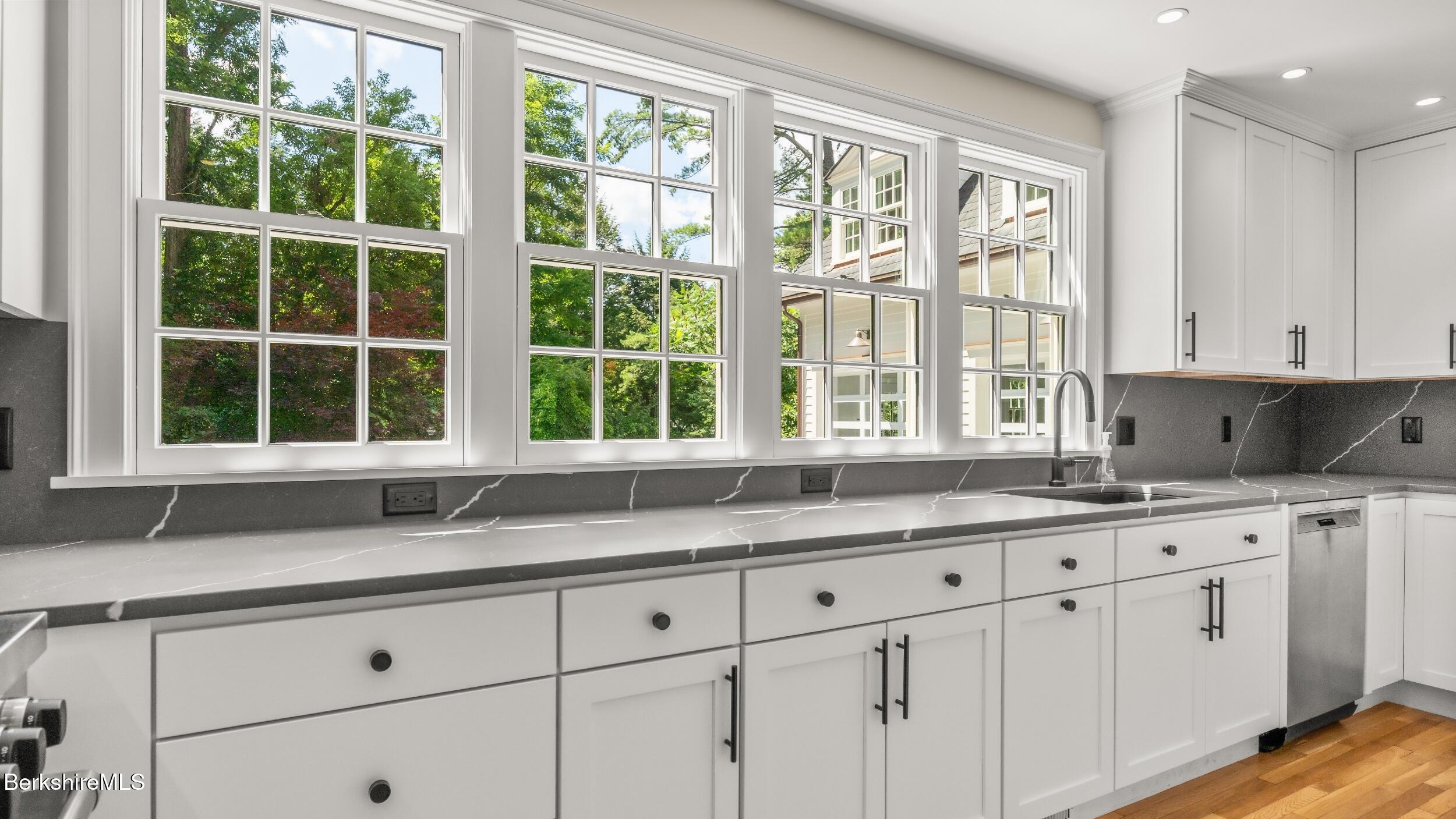 55 Main Street Stockbridge, MA 01262 - Photo 13 of 54 a kitchen with granite countertop white cabinets and a window
