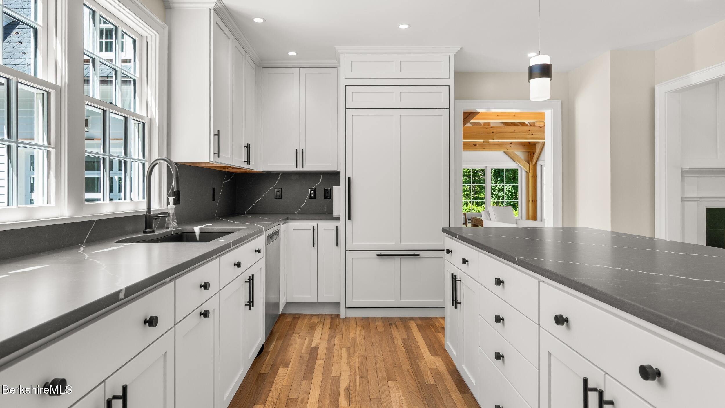 55 Main Street Stockbridge, MA 01262 - Photo 15 of 54 a kitchen with granite countertop a sink stove and cabinets