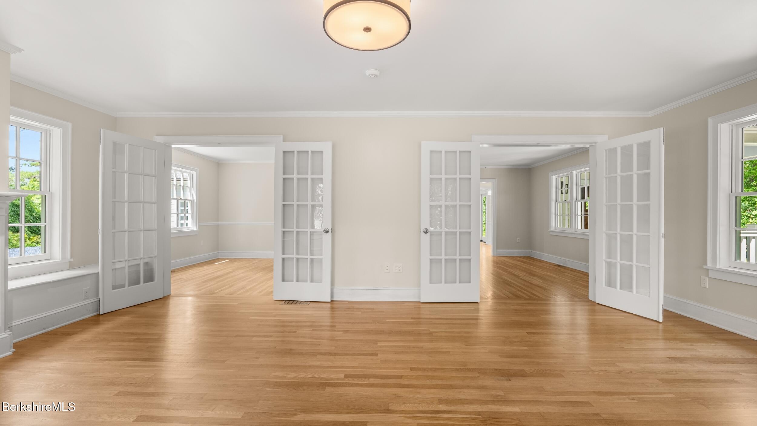 55 Main Street Stockbridge, MA 01262 - Photo 23 of 54 a view of an empty room with wooden floor and windows