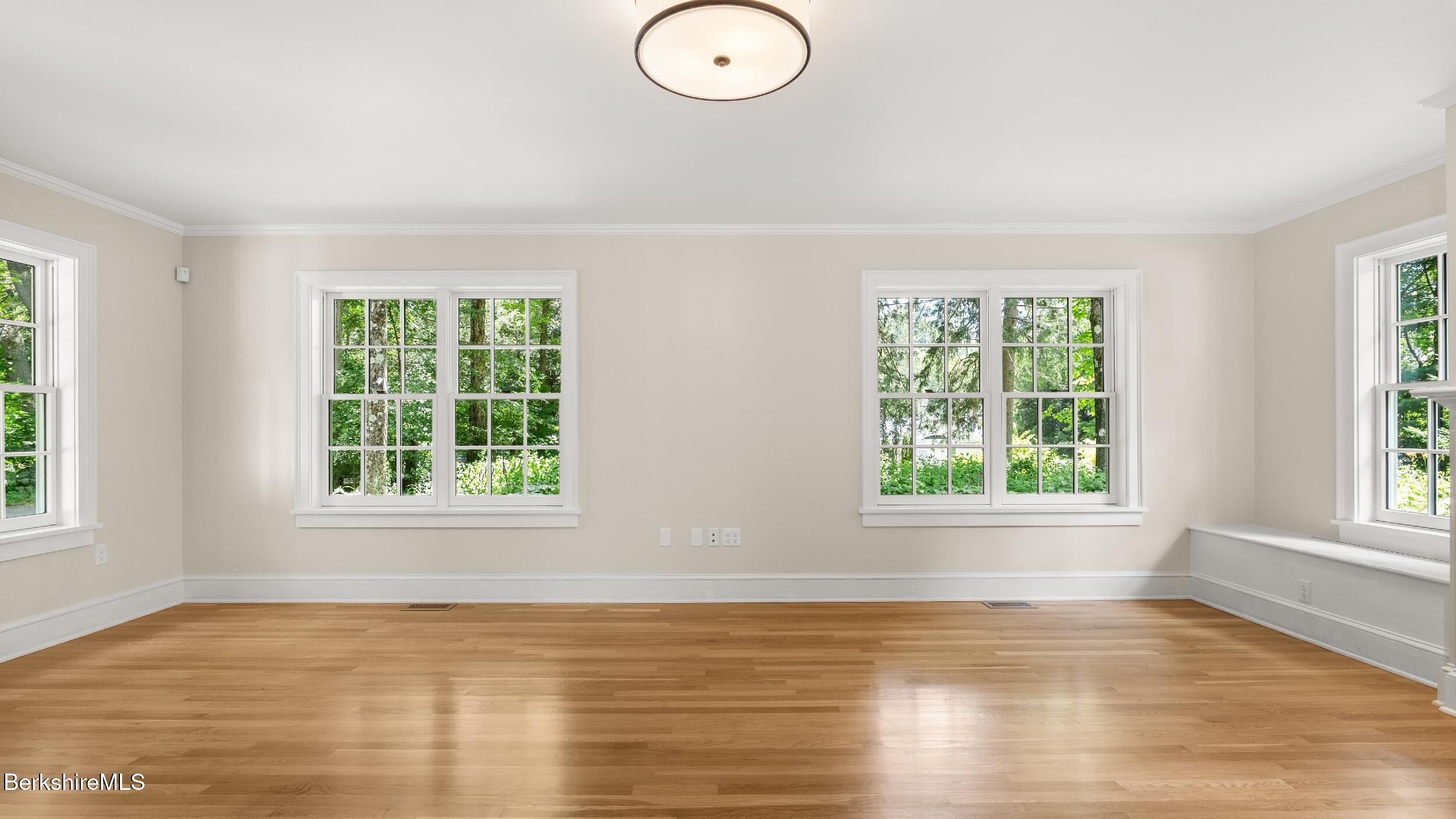 55 Main Street Stockbridge, MA 01262 - Photo 25 of 54 an empty room with wooden floor and windows