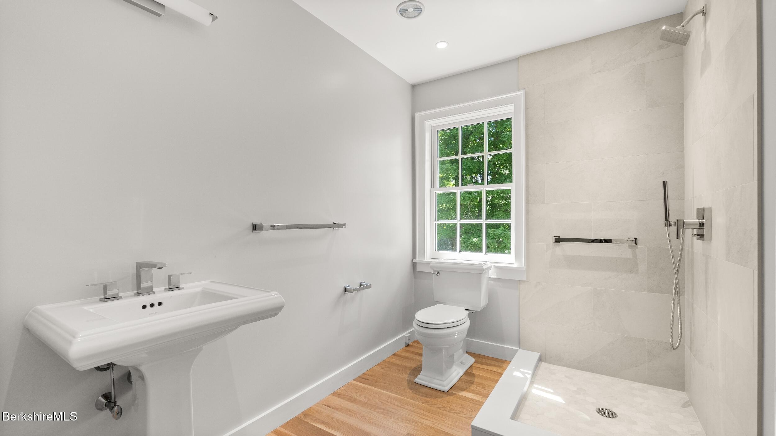 55 Main Street Stockbridge, MA 01262 - Photo 36 of 54 a bathroom with a sink toilet a mirror and shower