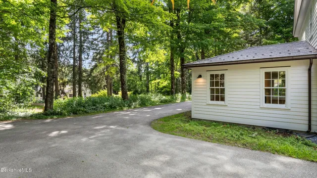a view of a house with a window and wooden fence
