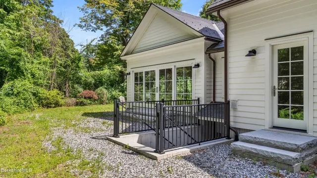 an aerial view of a house with a yard basket ball court and outdoor seating