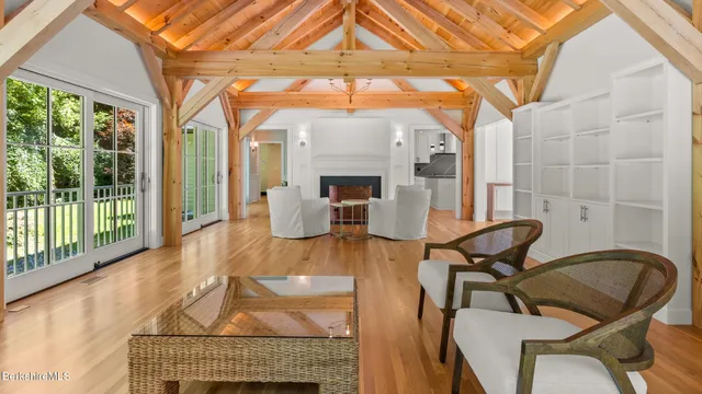 a dining room with wooden floor outdoor seating and nature