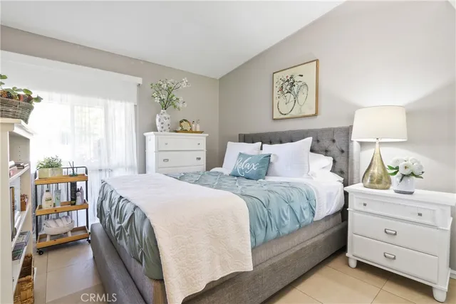 a bedroom with a bed and a painting on the wall