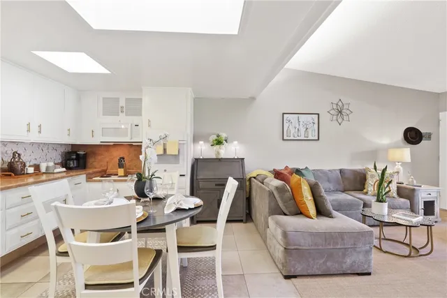 a living room with furniture and kitchen view