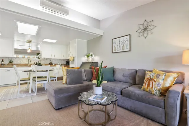 a living room with furniture kitchen and a table