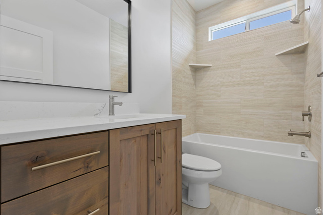 728 East Mountain Road North Ogden, UT 84414 - Photo 15 of 28 Bathroom featuring a wood-finish vanity with a light-toned countertop, a rectangular undermount sink, and a brushed nickel faucet