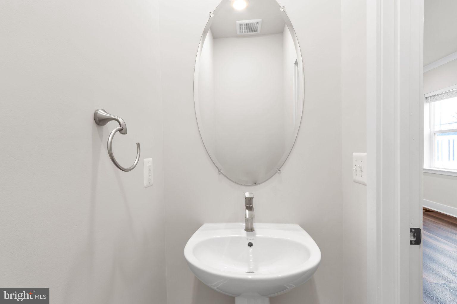 2216 Partin Road Windsor Mill, MD 21244 - Photo 11 of 25 a bathroom with a sink and mirror