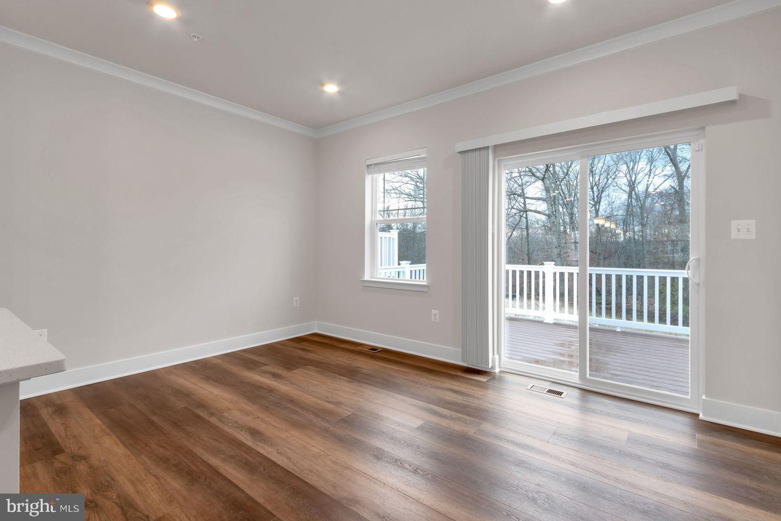 2216 Partin Road Windsor Mill, MD 21244 - Photo 12 of 25 an empty room with wooden floor and windows