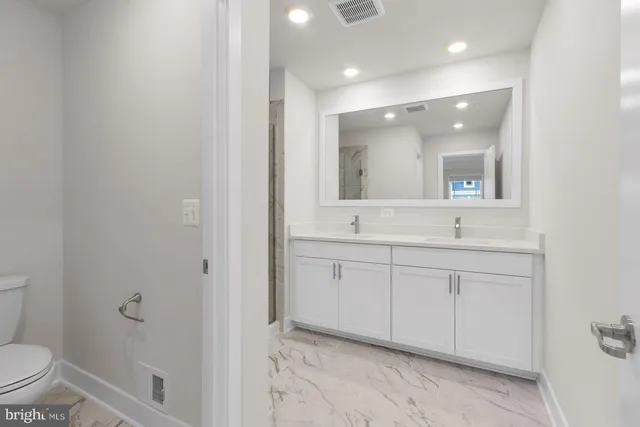 a bathroom with a shower sink and mirror