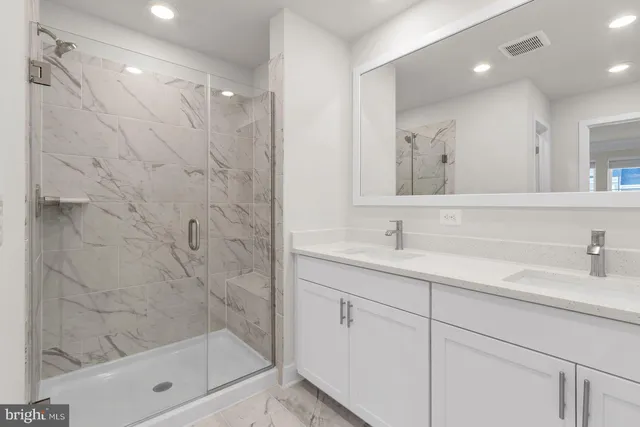 a bathroom with a granite countertop sink a toilet and bathtub