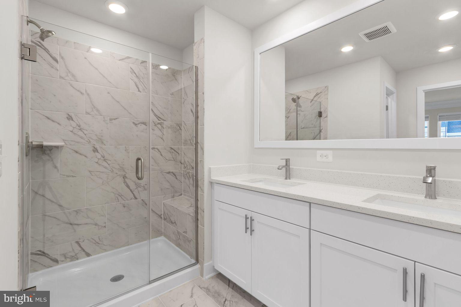 2216 Partin Road Windsor Mill, MD 21244 - Photo 17 of 25 a bathroom with a shower sink and mirror