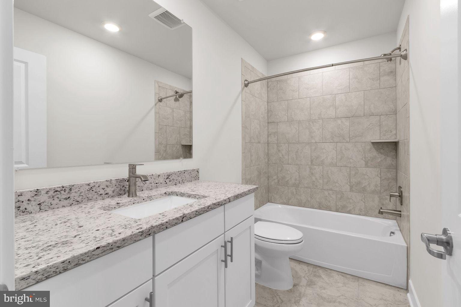 2216 Partin Road Windsor Mill, MD 21244 - Photo 18 of 25 a bathroom with a granite countertop sink a toilet and bathtub