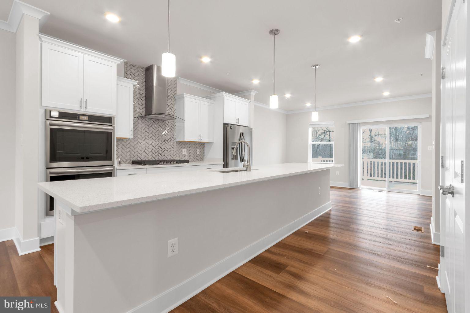 2216 Partin Road Windsor Mill, MD 21244 - Photo 6 of 25 a large kitchen with kitchen island a large counter top space a sink stainless steel appliances and cabinets