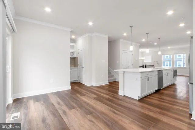 a view of kitchen with kitchen island and stainless steel appliances