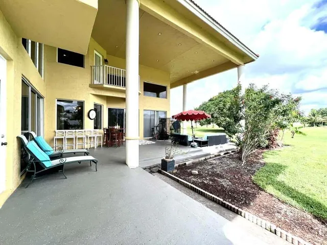 a swimming pool with outdoor seating and yard