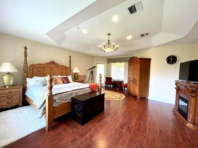 a bed room with furniture and a wooden floor