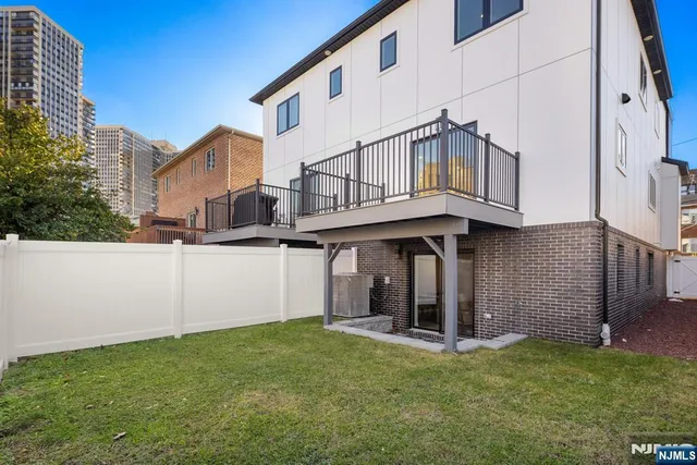 a view of a house with a wooden fence