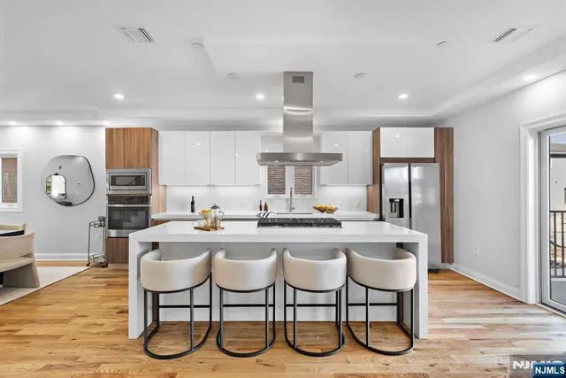 a kitchen with granite countertop a table chairs stove and cabinets