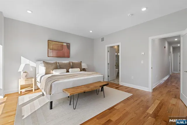 a bedroom with a bed and a table